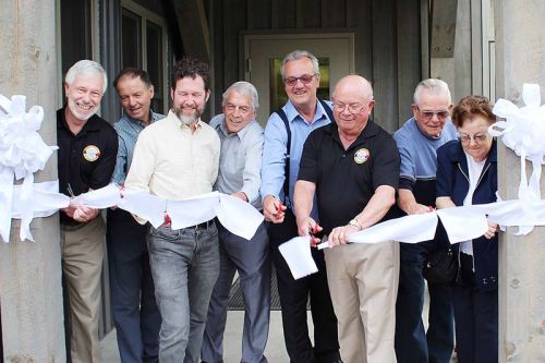 Both sitting and former politicians lined up to cut the ribbon on the revamped Township office in Plevna including (from left) Mayor Ron Higgins, Coun. John Ingles, MP Scott Reid, Coun. Vernon Hermer, MPP Randy Hillier, Coun. Gerry Martin, and former Council members Dave Smith and Barb Sproule. Photo/Craig Bakay